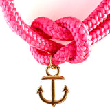 Closeup pic of the gold anchor charm on the pink rope bracelet
