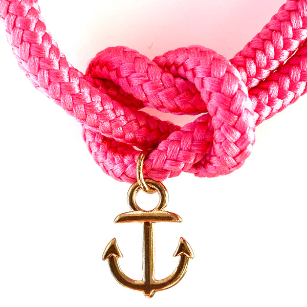 Closeup of the gold anchor charm  on the hot pink sailor knot bracelet