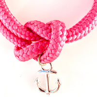 Close up of the Silver anchor charm on hot pink sailor knot bracelet
