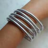 Set of 5 silver bangles on arm