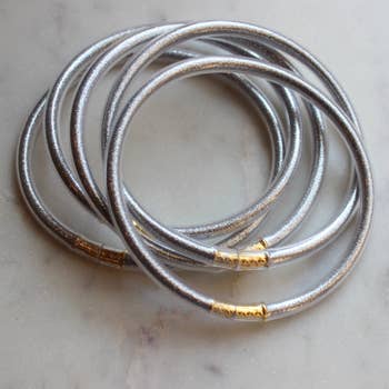 5 piece set of silver metallic tube bangles