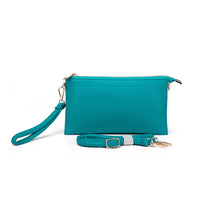 Turquoise This is IT! bag shown with wristlet strap attached and OTS/crossbody strap in front of the clutch (shown here as a wristlet)